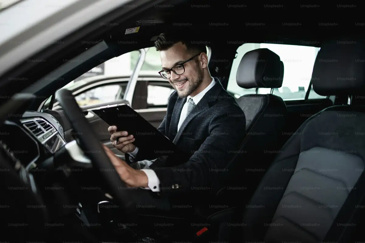 Car seller working in showroom and quality control checking of car details for the last time before buyer comes.
